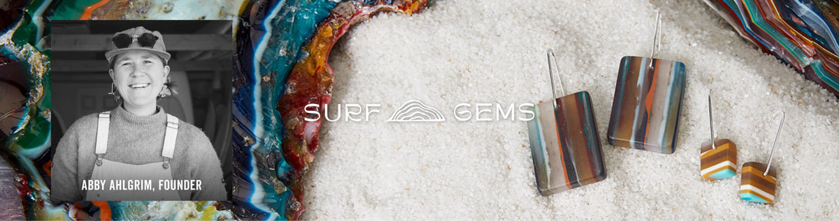 A promotional banner for Surf Gems jewelry featuring three pairs of striped resin stud earrings in brown, blue, and orange tones, alongside a black-and-white photo of Abby Ahlgrim, founder, and colorful wave-patterned fabric.
