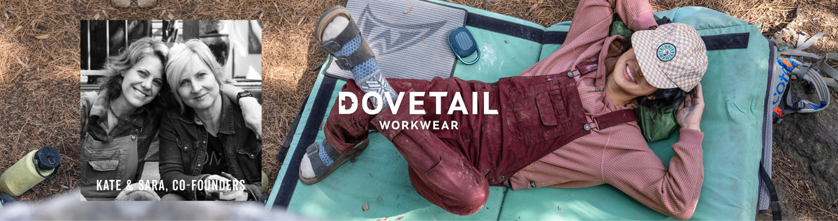 A lifestyle banner for Dovetail Workwear featuring a woman in red overalls and a pink shirt lying on a teal camping mattress outdoors, alongside a black-and-white inset photo of co-founders Kate & Sara.