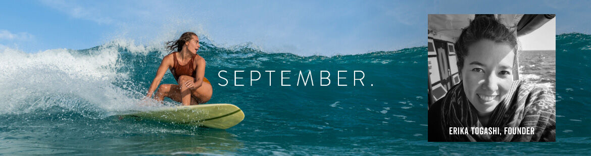A promotional banner for September featuring a woman riding a surfboard on a large ocean wave on the left, with the word 'SEPTEMBER.' in white text across the center, and a black-and-white portrait of the same woman labeled 'ERIKA TOGASHI, FOUNDER' on the right.