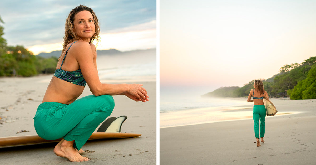 A woman in a teal patterned sports bra and bright green leggings poses on a beach with a surfboard, with a second view showing her walking away on the sand toward the ocean at sunset.