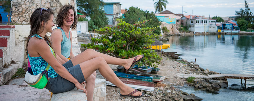 Women in tropical travel clothes talking